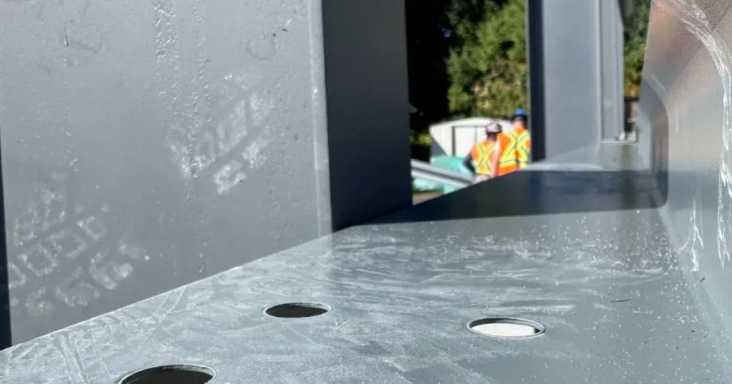 Close-up of Tower Steel Buildings engineered steel frame in Ontario showing precision holes and structural durability compared to wood construction