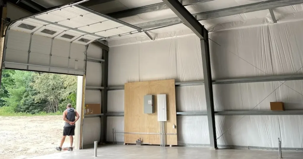 Interior of a Tower Steel Buildings pre-engineered steel garage in Ontario with insulated panels and exposed steel framing