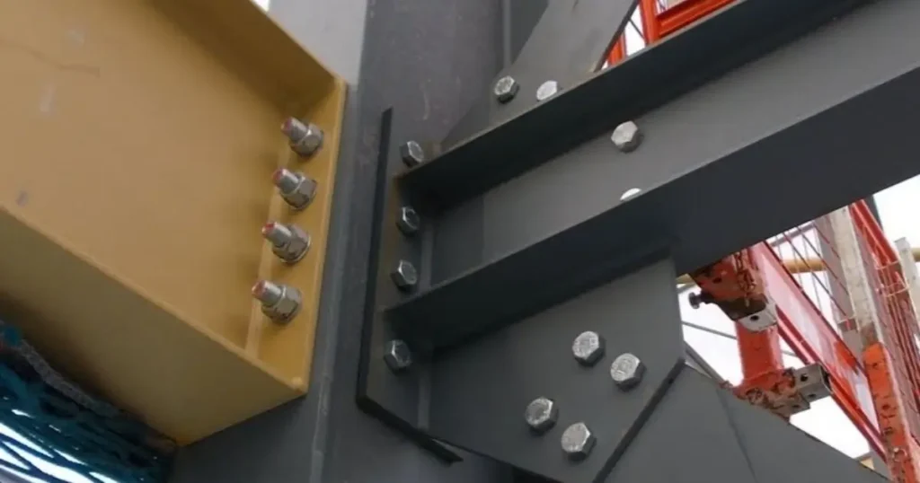 Close-up of steel beam connection engineered by Tower Steel Buildings showing high-strength bolts and precision fabrication in Ontario