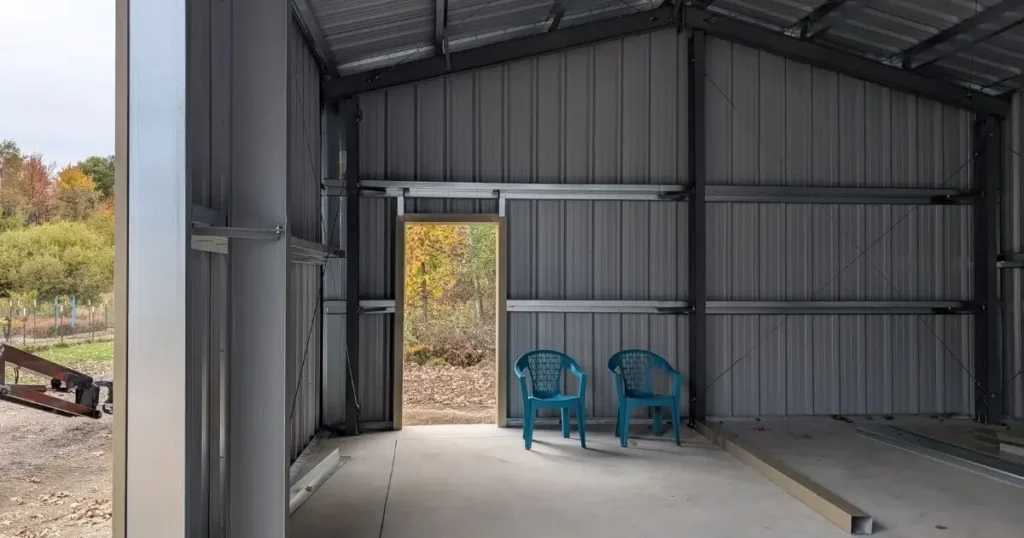 Interior of a pre-engineered steel building in Ontario showing steel frame, roof panels, and concrete floor