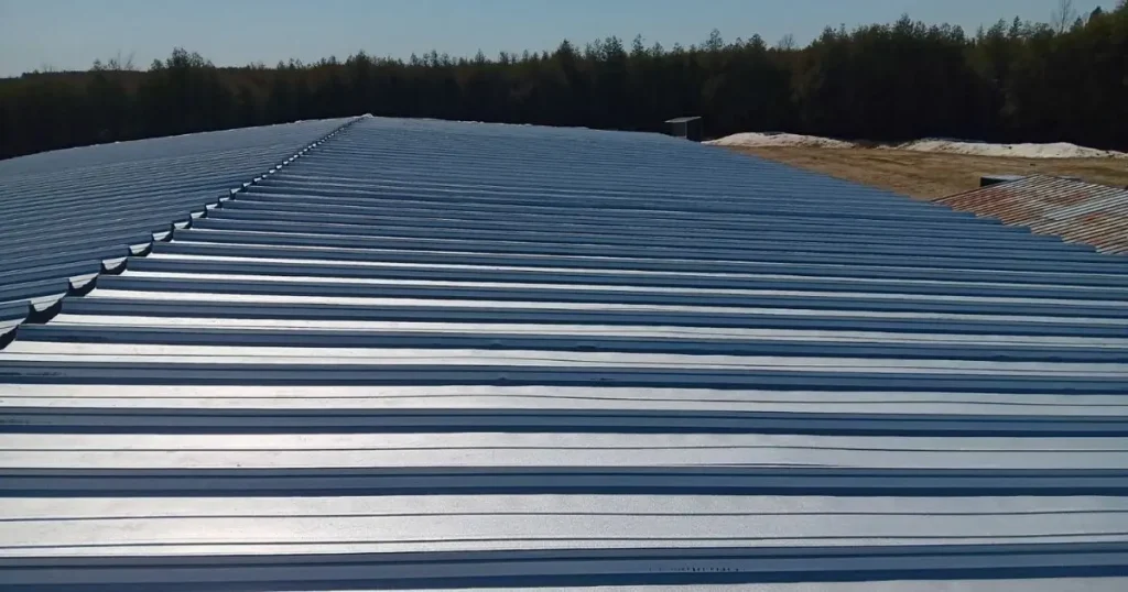 Close-up of steel roof panels under bright sunlight representing custom engineering and cost variation in Ontario steel buildings