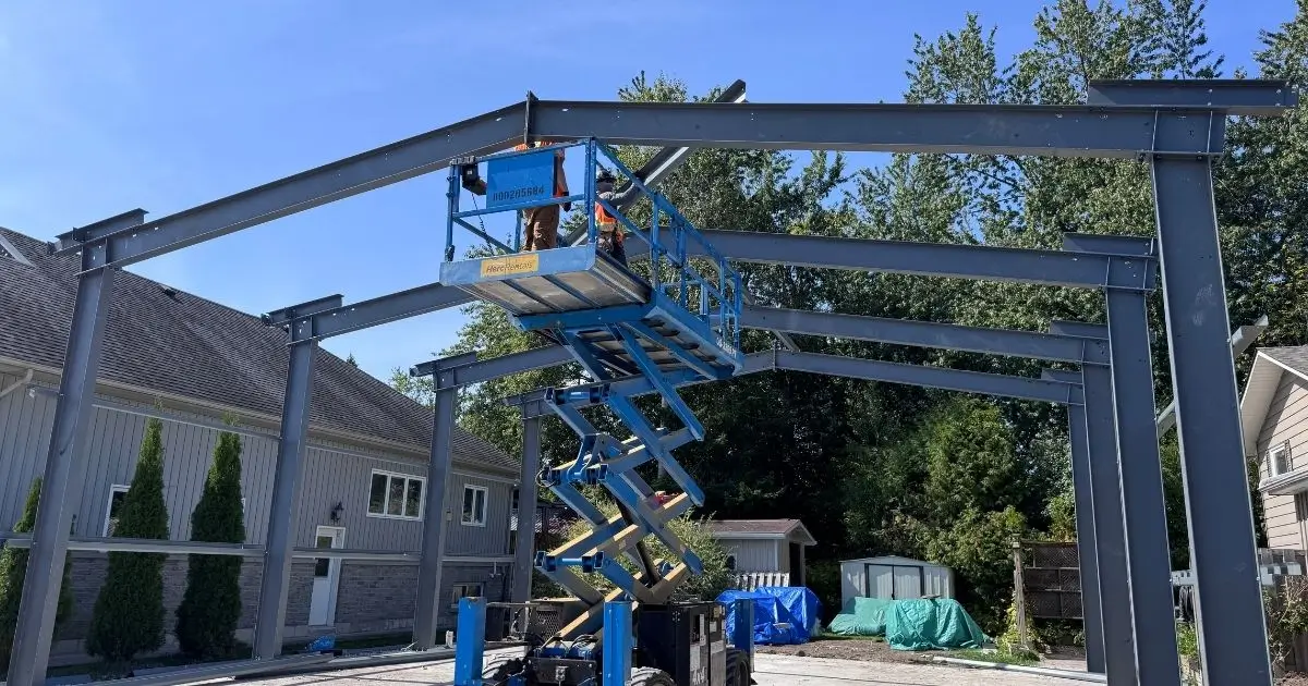 Steel building frame installation in Ontario by Tower Steel Buildings showing early construction and precise alignment work
