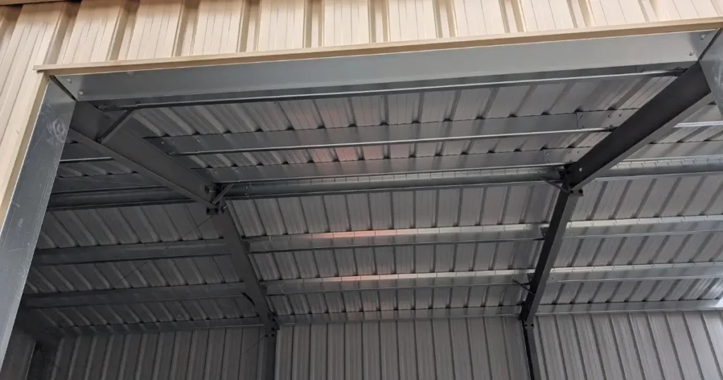 Interior framing of a steel garage workshop in Ontario by Tower Steel Buildings showing strong steel beams and roof panels