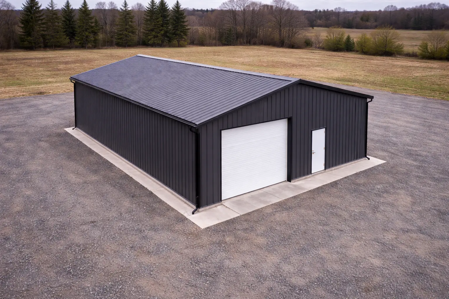 30x50x14 contractor steel workshop aerial perspective showing full building footprint, roof system, and surrounding worksite environment.