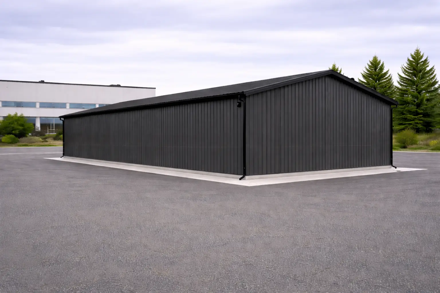 front corner view of 30x60x16 clear span steel workshop with dual overhead doors and side access door.