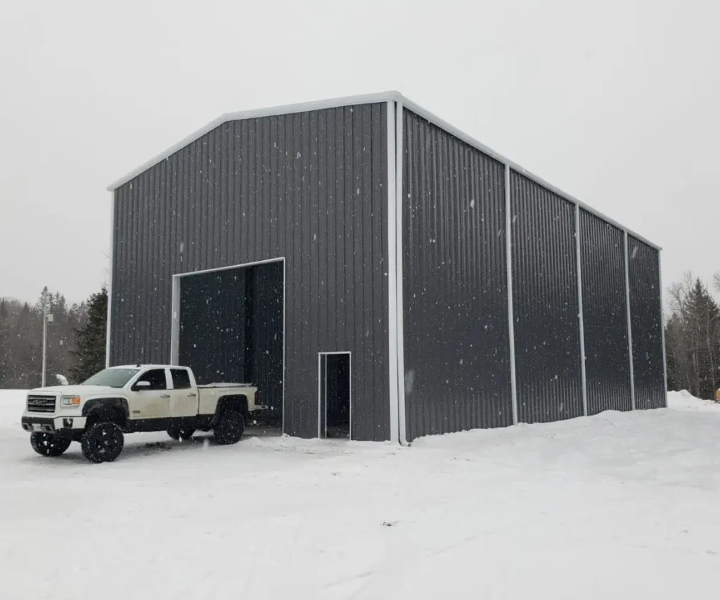 Steel workshop building in Ontario in winter with a pickup truck