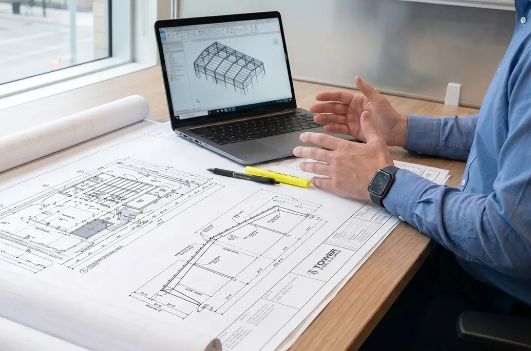 Steel building permit Alberta site with foundation anchors and structural frame under construction