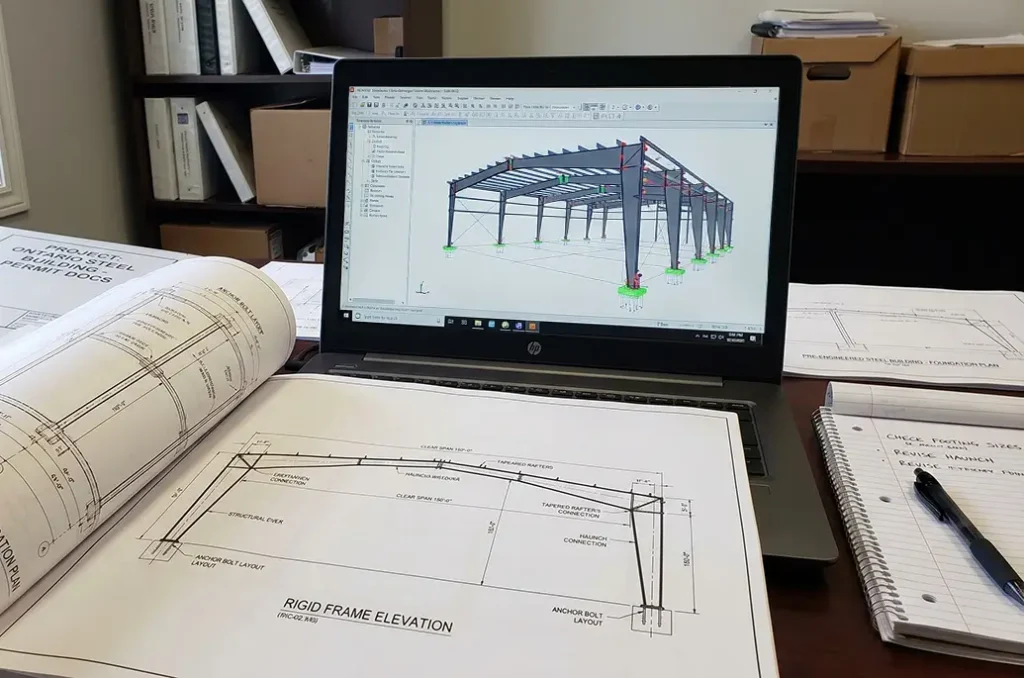 steel building permit application Ontario drawings and structural design on desk